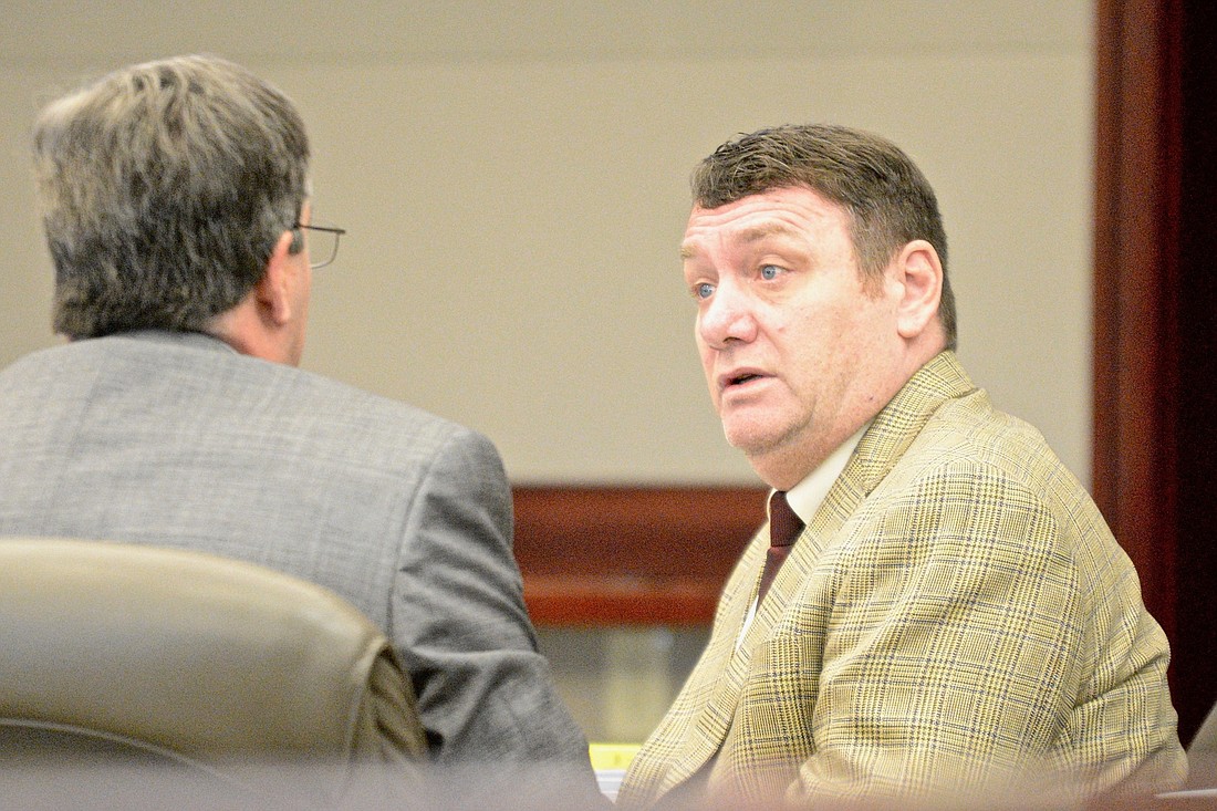 Defendant Michael Craig Bowling speaks to his attorney, William Bookhammer, in court Feb. 19. (Photo by Jonathan Simmons)