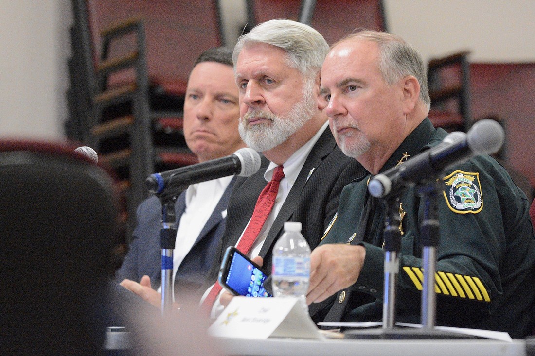Clerk of Court Tom Bexley, interim County Administrator Jerry Cameron and Sheriff Rick Staly listen to commissioners during a County Commission meeting  Feb. 21. (Photo by Jonathan Simmons)