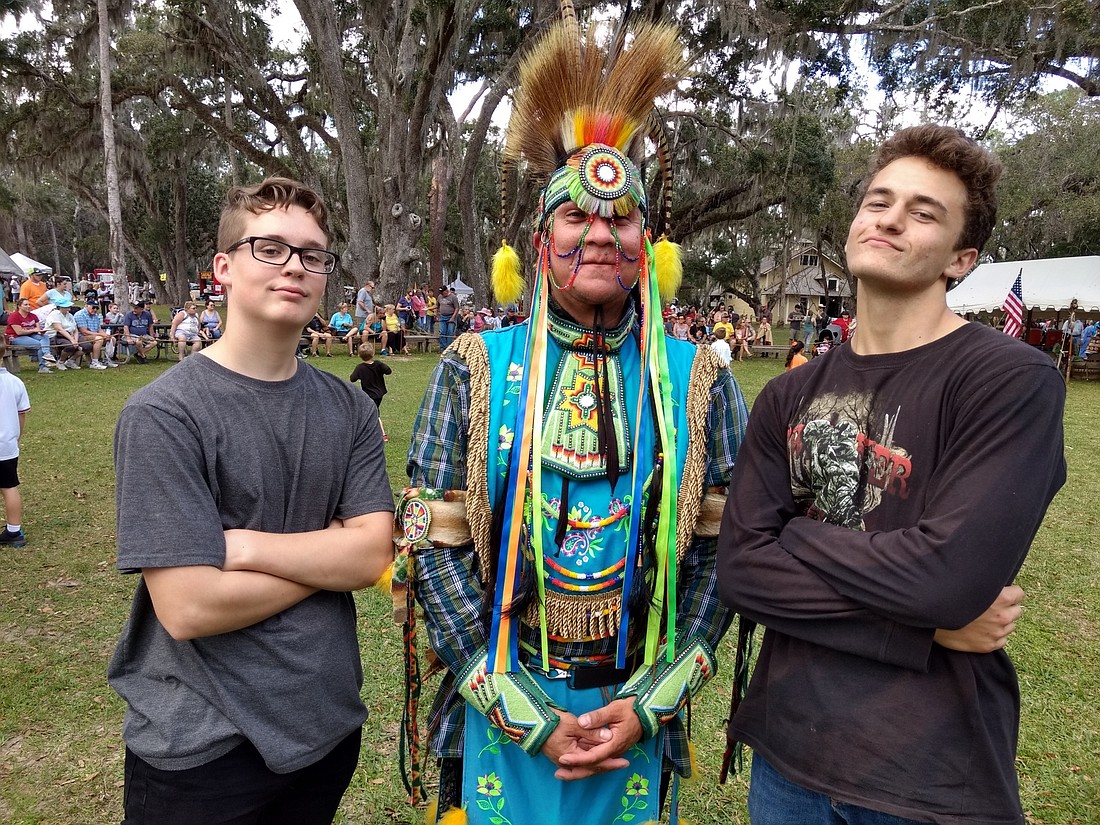 Joseph Hoffmann and David Wilcox pose with a dancer at the Native American Festival on Feb. 23, at Princess Place Preserve. Photo by Brian McMillan