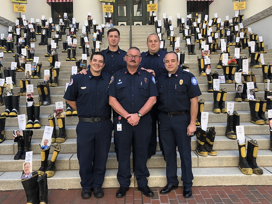 Fire Lt. Richard Cline, center, placed his boots on the steps of the State Capitol for firefighter cancer. Firefighter Joseph Fajardo, Cline, Deputy Chief Bradd Clark. Back: Firefighters Daniel Hackney and Patrick Juliano