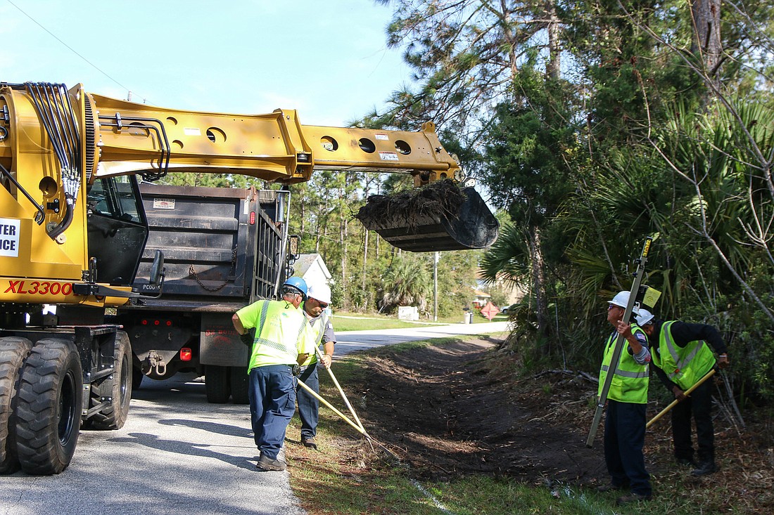 City of Palm Coast workers John Caccavale (not shown), Bobby Pearson, John Delbonis, Jeffrey Starr and part-time employee Deshawn Barbero repair the swale on Providence Lane in Palm Coast on March 15. Photo by Paige Wilson
