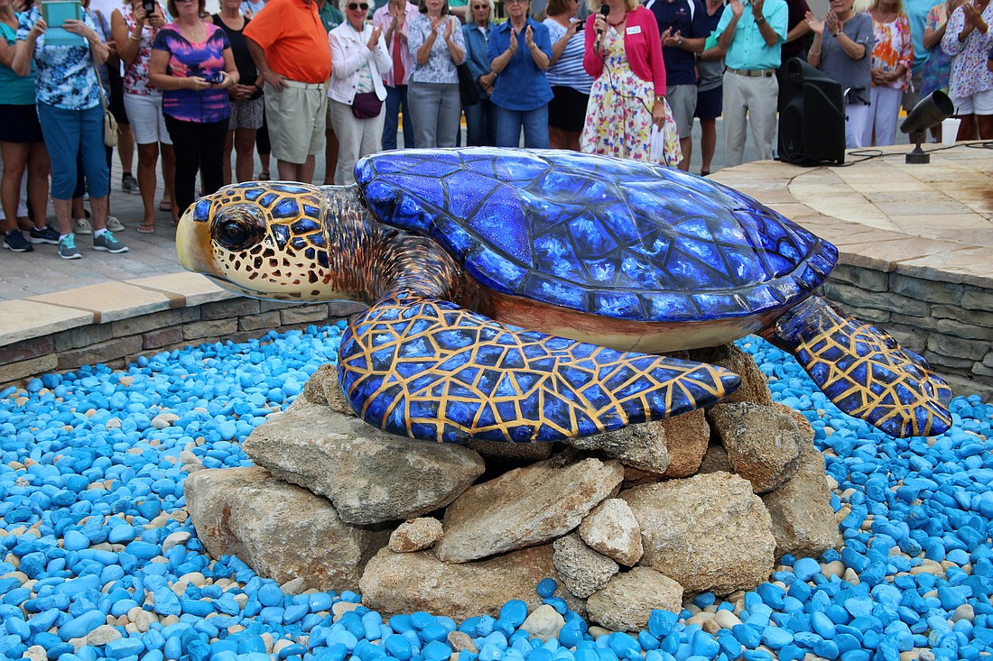 The newest turtle sculpture on the Public Sculpture Turtle Trail, €œMarc-Sea,' was dedicated March 25 at the Village Center in Grand Haven. Courtesy photo by Eric Vardakis, Live Tour Network Inc.