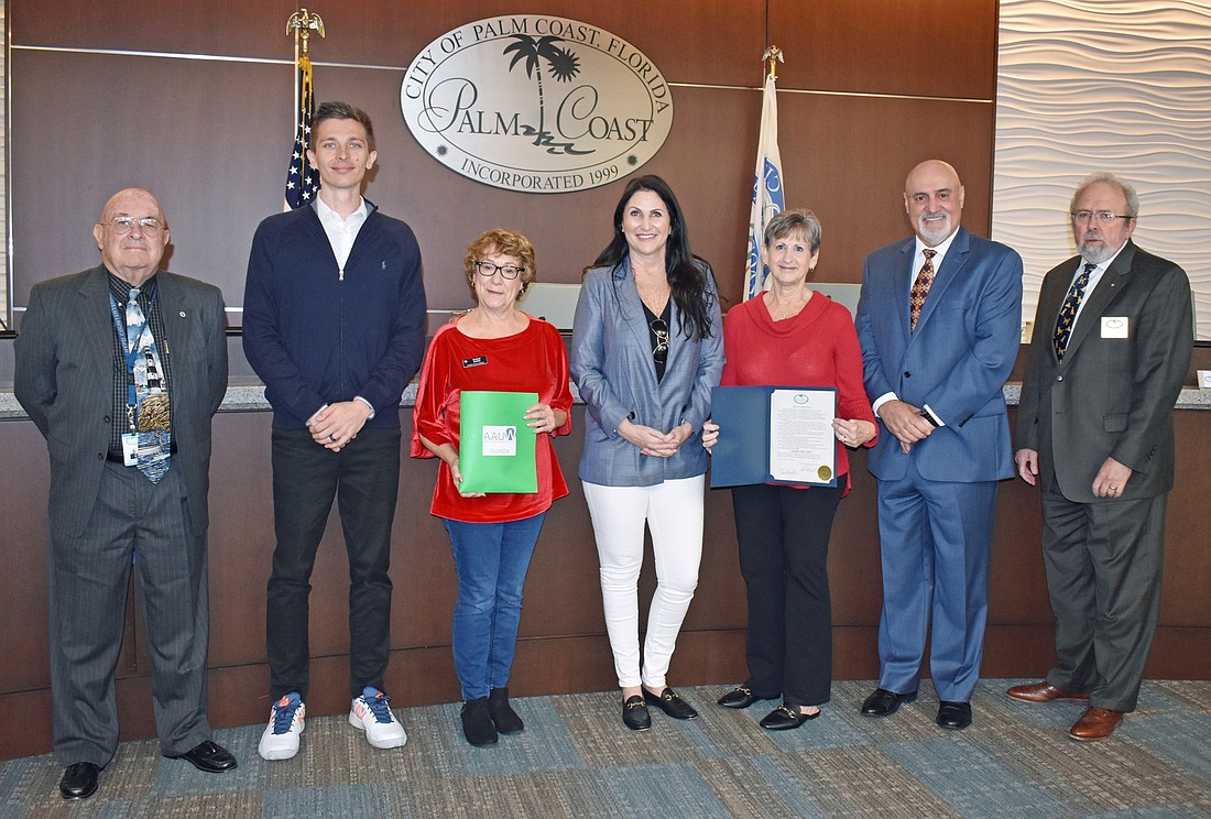 AAUW Flagler co-presidents Susan Baird and Theresa Owen meet with Palm Coast City Council members Jack Howell, Nick Klufas, Eddie Branquinho and Robert Cuff and Mayor Milissa Holland to recognize Equal Pay Day. Courtesy photo