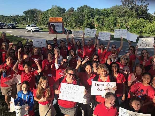 Teachers, staff, administrator and community members participate in a walk-in at Wadsworth with  Flagler County Educators Association, wearing all red in support of public education. Courtesy photo