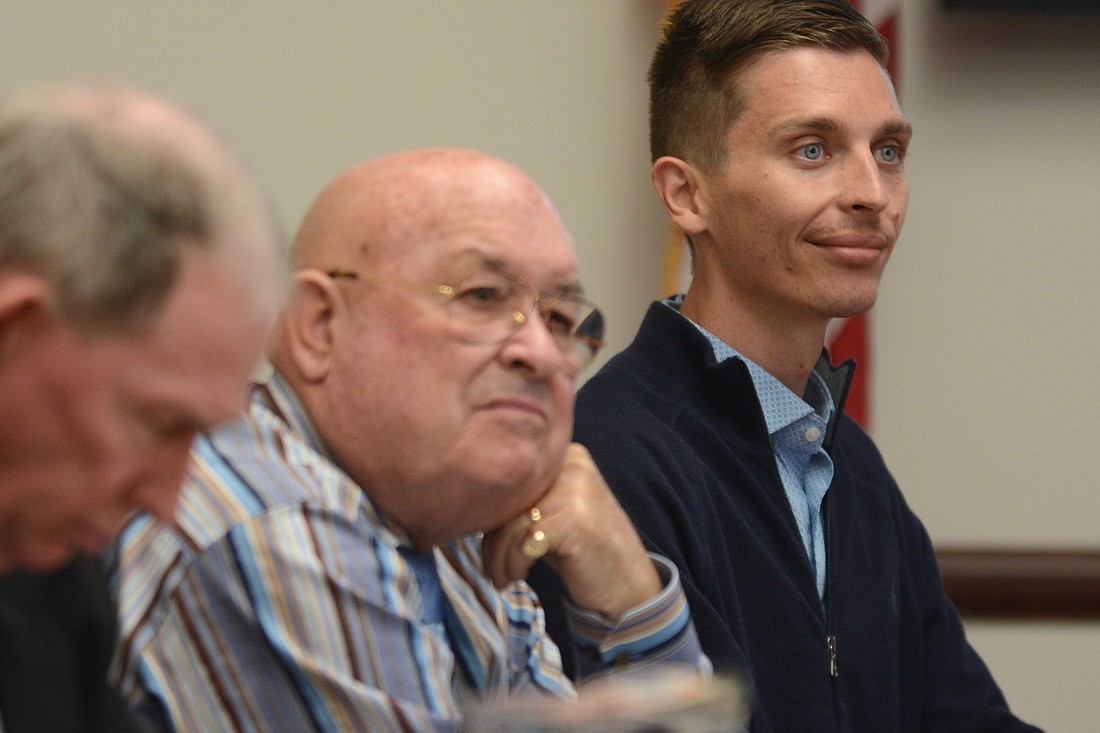 City Councilman Nick Klufas, right, and City Councilman Jack Howell listen to a resident speak at a City Council workshop. (Photo by Jonathan Simmons)