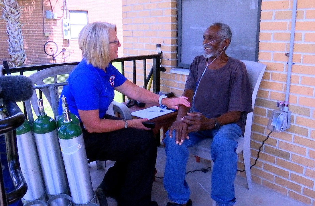Caryn Prather with a patient (Photo courtesy of the Flagler County government.)