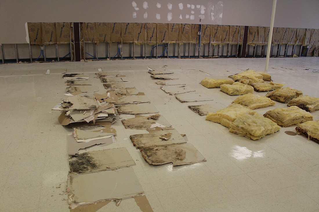 Wet sheetrock and insulation removed from the eastern wall of the Sears building by county employees. (Photo courtesy of the Flagler County government.)
