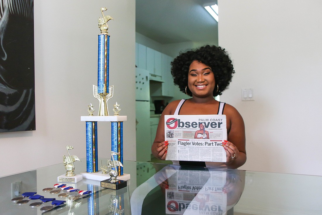 Ashia Barnes poses with her music awards and a 2012 copy of the Observer where she was recognized for winning the BTMS Idol. Photo by Paige Wilson