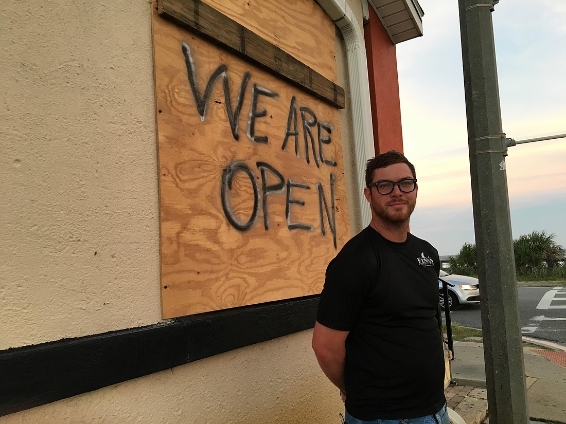 Nick Behling, fill-in manager at Finn's Beachside Pub, outside the bar, one of few establishments still open the Monday before Hurricane Dorian's trip past Florida. Photo by Joey Pellegrino