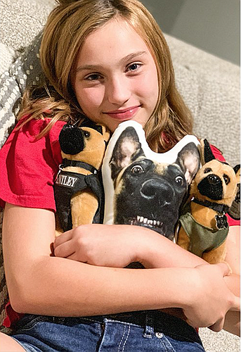 Emma Stanford, 11, and the K9 plush that inspired her fundraiser. Courtesy of the Stanford family