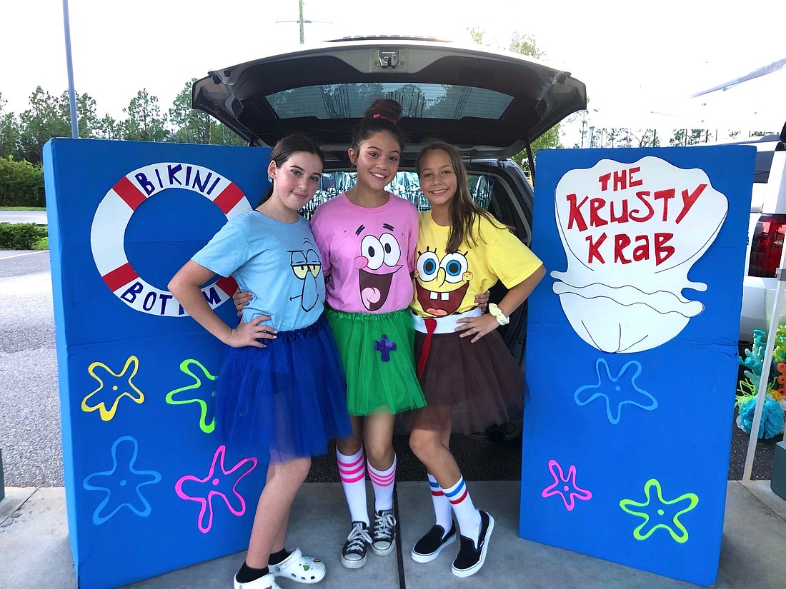 Mila McKee, Anabelle Moore, and Jordan Draugelat by their SpongeBob SquarePants-themed trunk. Photo courtesy of Imagine School
