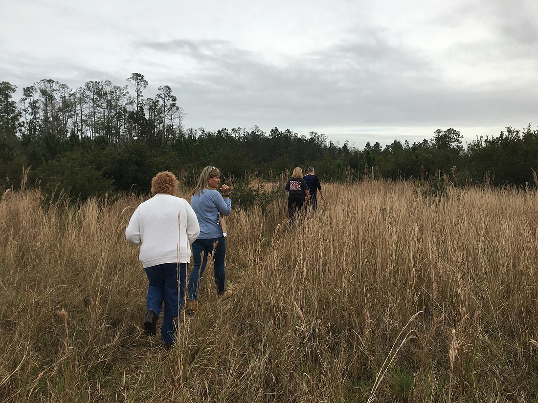 Lisa Cancel, Jacki Lausier, Caryn Prather and DeAnna Flaherty heading toward a homeless man's camp. Photo by Joey Pellegrino