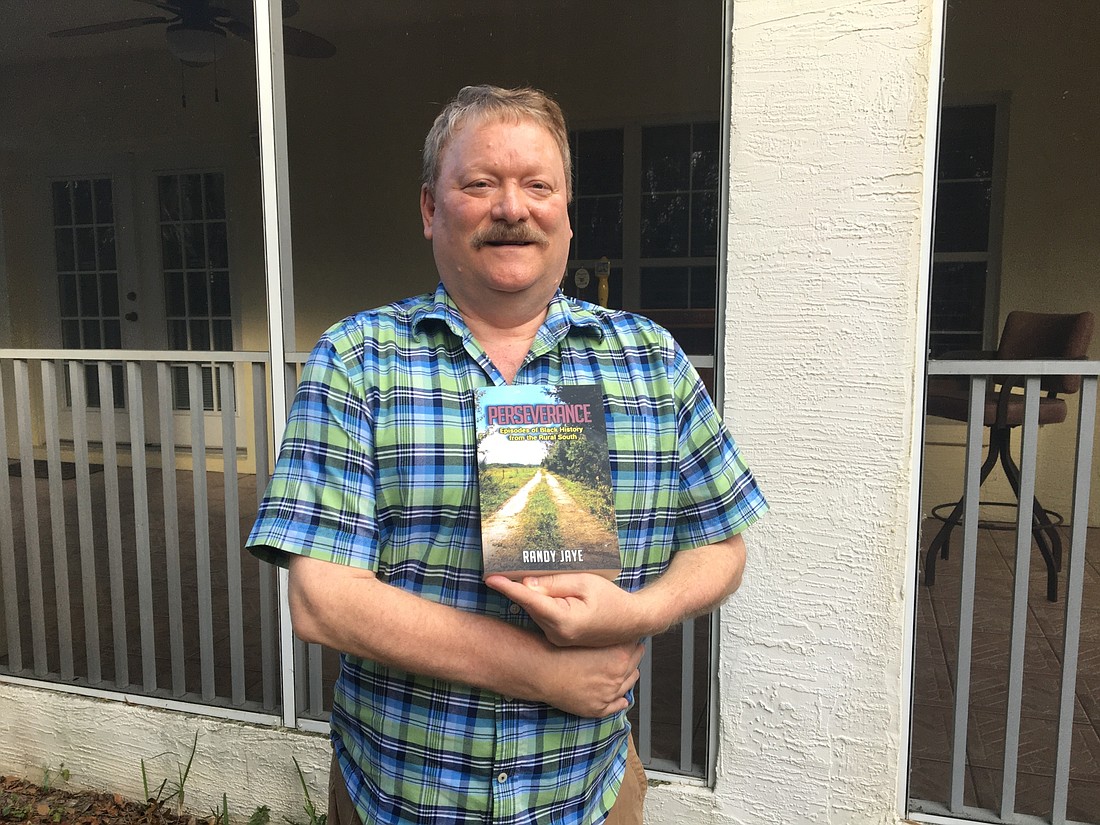 Randy Jaye holding his book. Photo by Joey Pellegrino