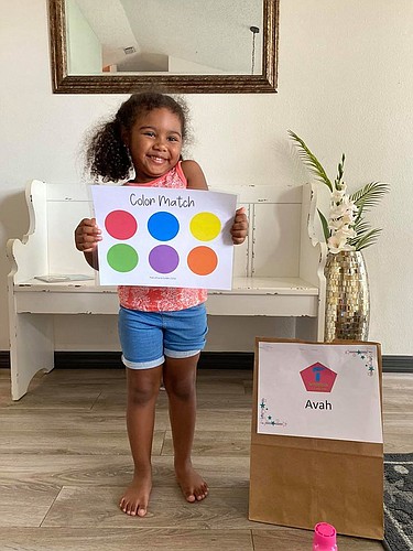 Avah Blackwell shows off part of a care package from her teacher at the Palm Coast Community Child Center. Photo courtesy of the the Palm Coast Community Child Center