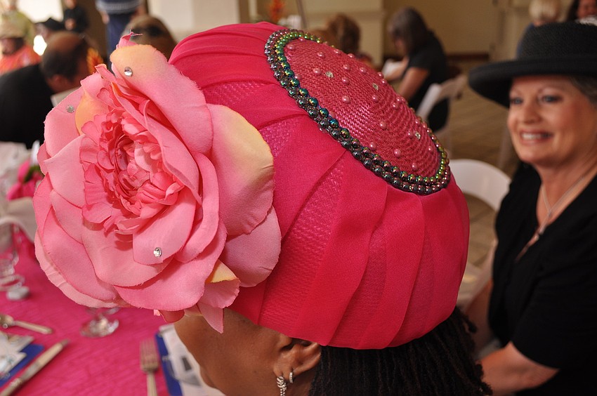 Brenda Belsito wore a bright hat with sparkles and a flower.