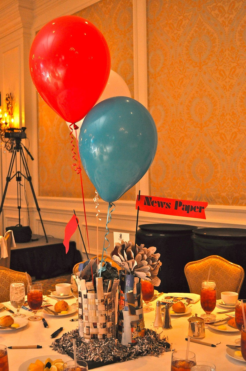 Media centerpieces focused on newspapers, magazines, film, social media and television filled tables.
