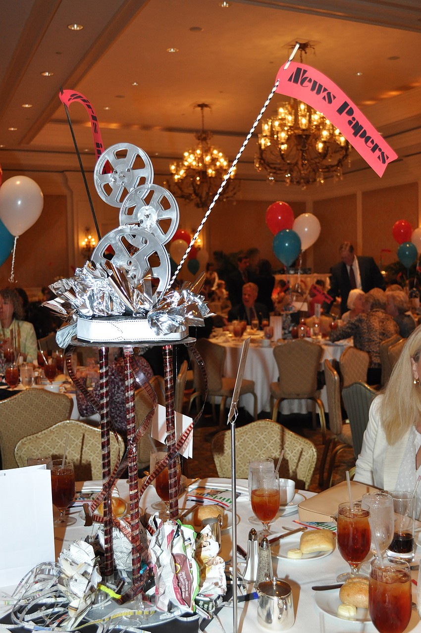 Media centerpieces focused on newspapers, magazines, film, social media and television filled tables.