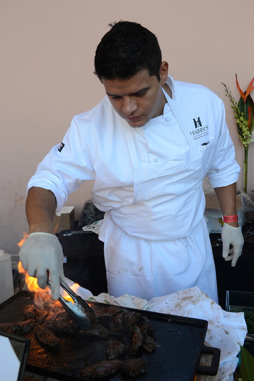 Jose Chichande grills skirt steak at the Harryâ€™s booth.