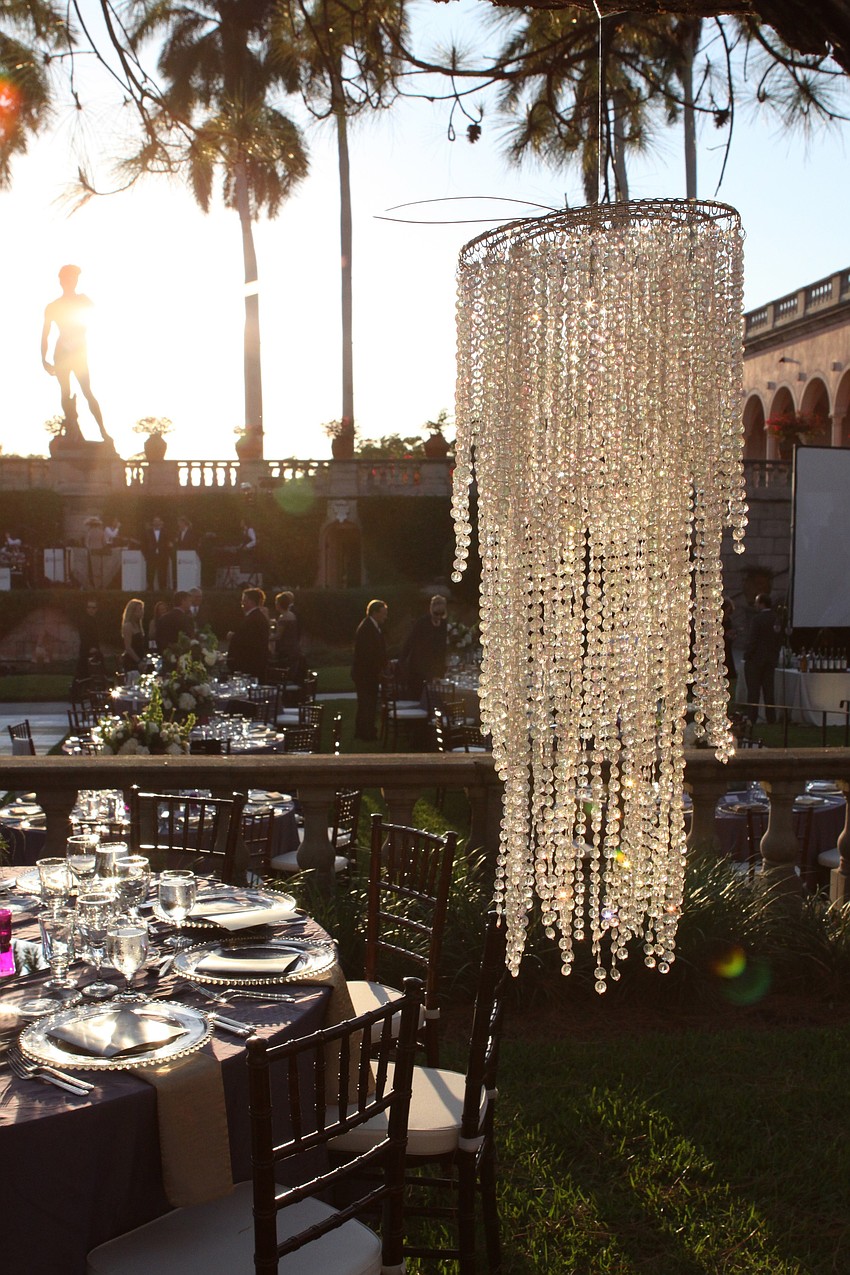 Crystal chandeliers hung from the trees to give a very dreamy look to the John & Mable Ringing Museum of Art Courtyard.