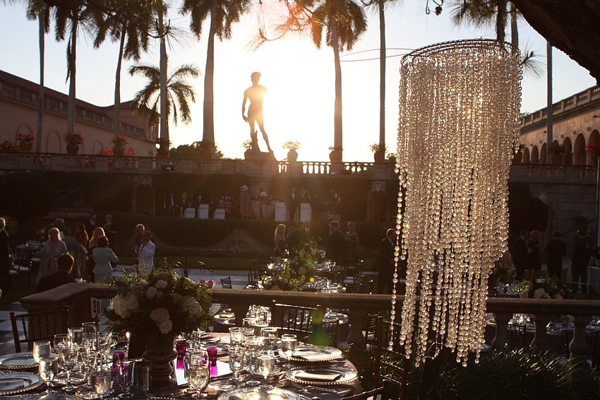 Crystal chandeliers hung from the trees to give a very dreamy look to the John & Mable Ringing Museum of Art Courtyard.
