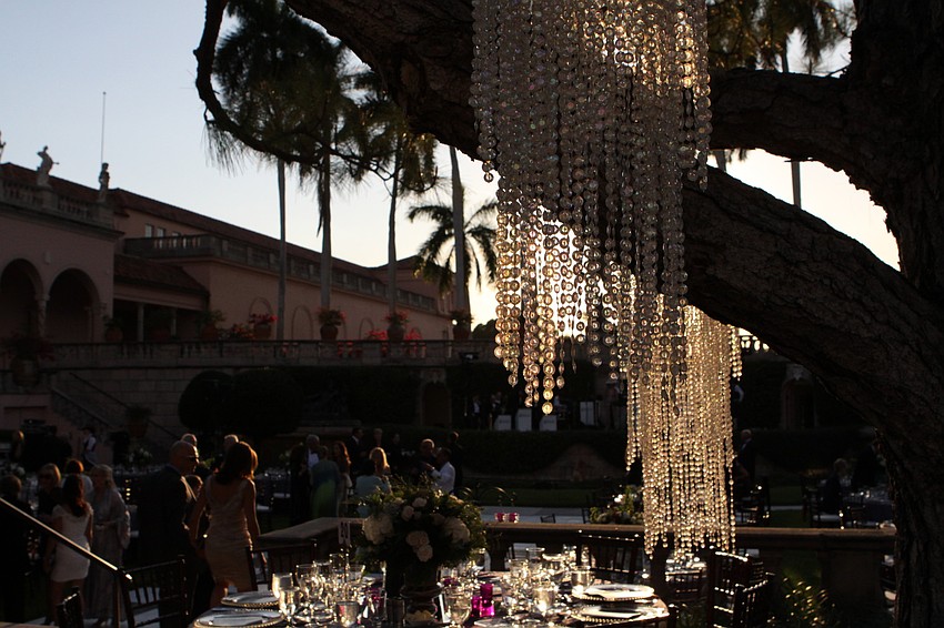 Crystal chandeliers hung from the trees to give a very dreamy look to the John & Mable Ringing Museum of Art Courtyard.