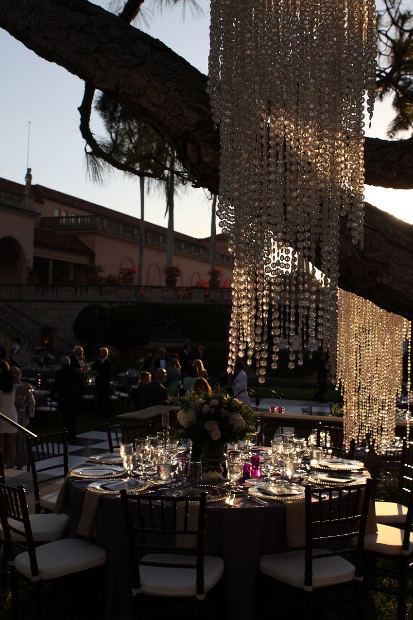 Crystal chandeliers hung from the trees to give a very dreamy look to the John & Mable Ringing Museum of Art Courtyard.