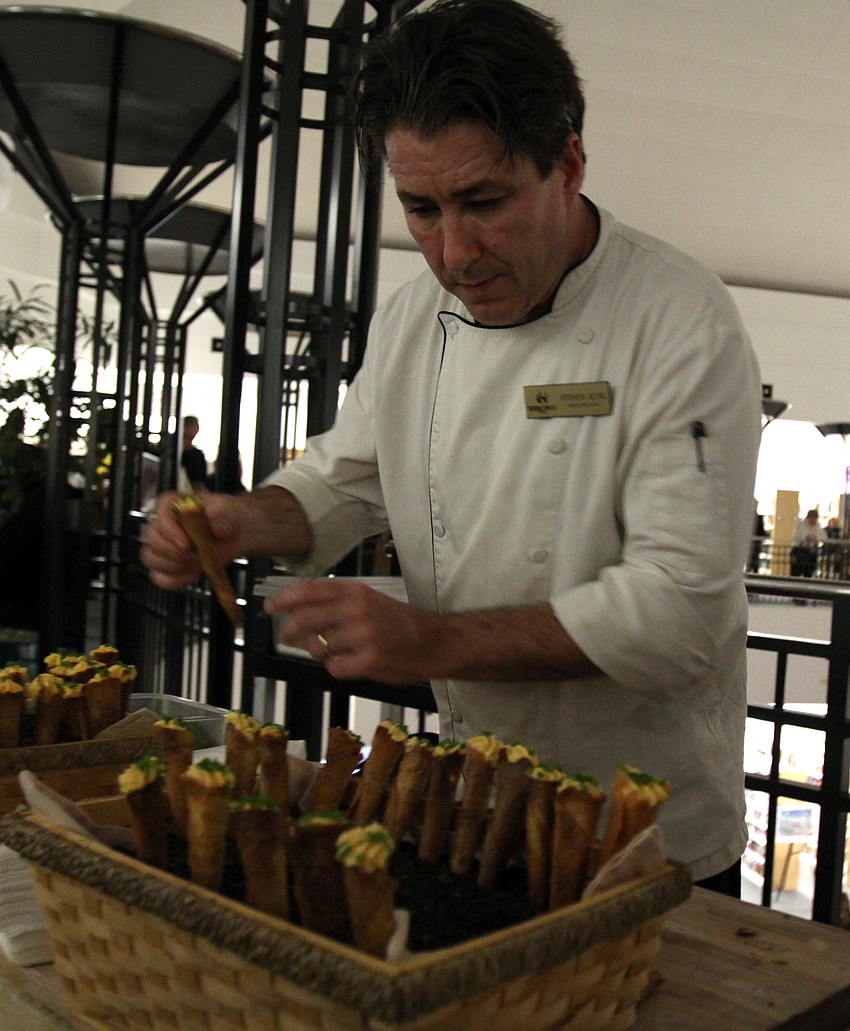 Steven King, Executive Chef at Helmsley Sandcastle Hotel, works on making cheddar mousse coronets.