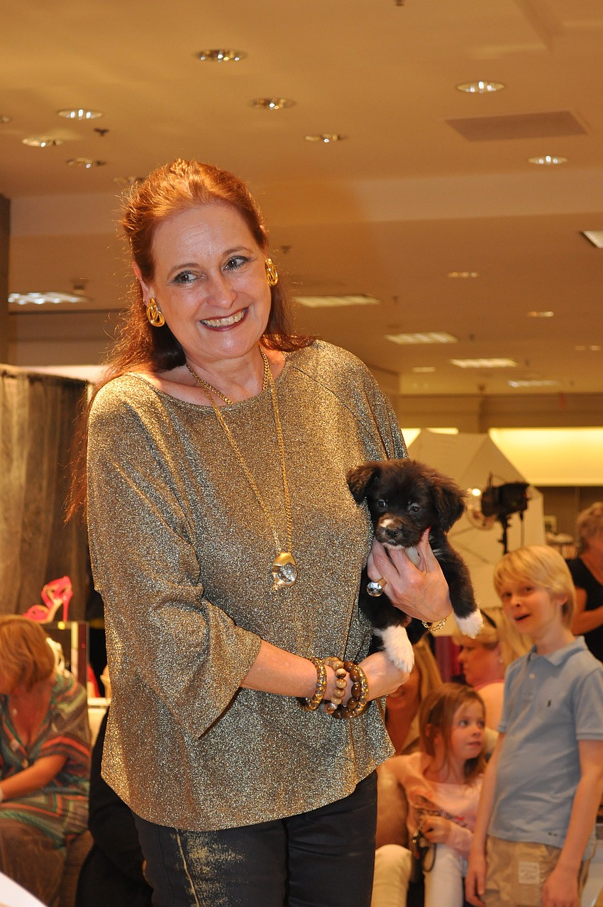 Flora Major showcases a puppy waiting to be adopted.