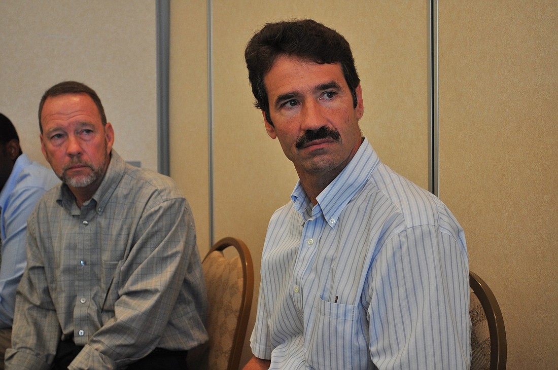 Schroeder-Manatee Ranch CFO Tony Chiofalo, right, and Vice President of Development Bob Simons, behind, today spoke with representatives of the IDA about Braden River Utilities capital improvement projects.