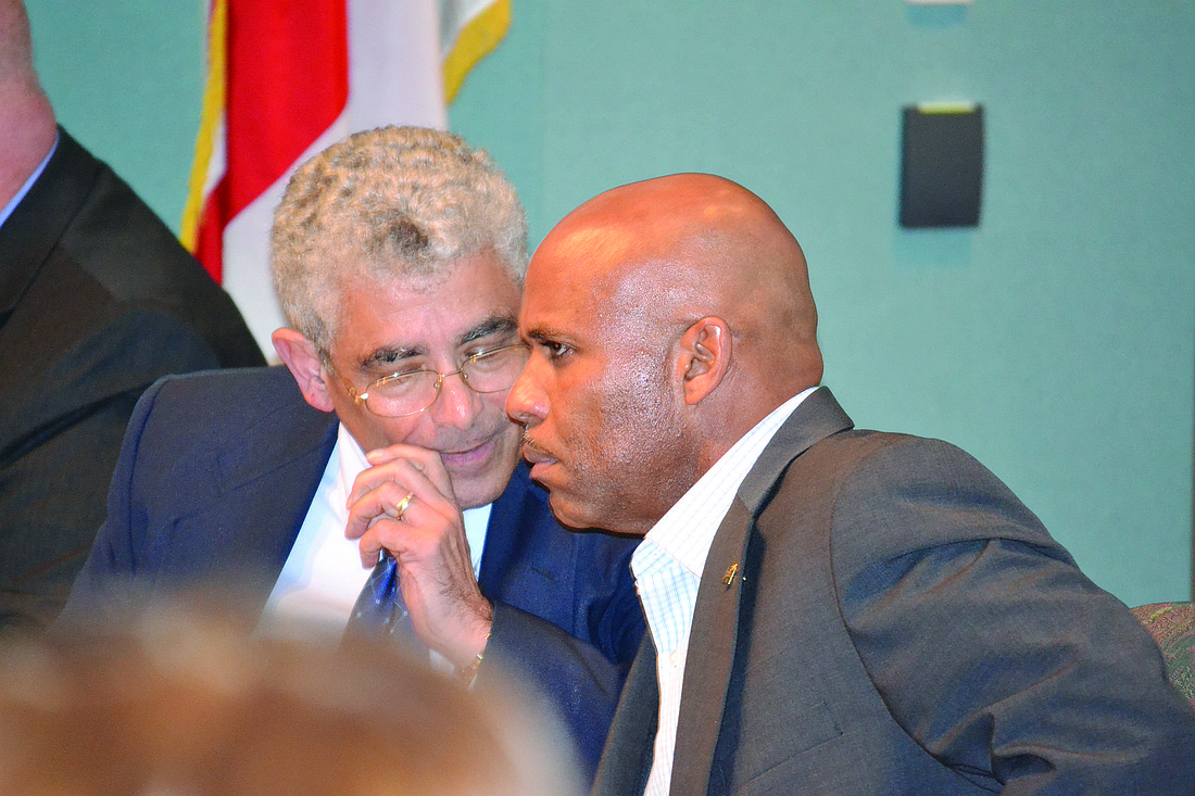 City Manager Bob Bartolotta and Deputy Manager Marlon Brown confer during Friday's special meeting that brought up numerous accusations against them.