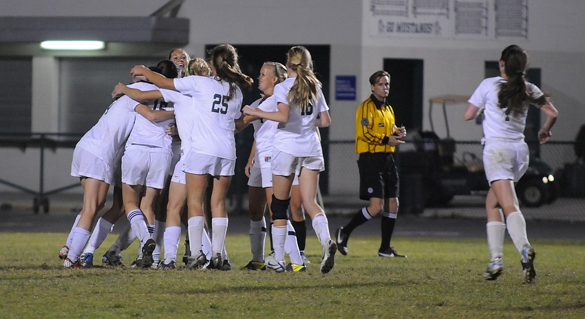 The Lakewood Ranch High girls soccer team celebrates following Tyler Gordonâ€™s game-tying goal with less than a minute to play in regulation.