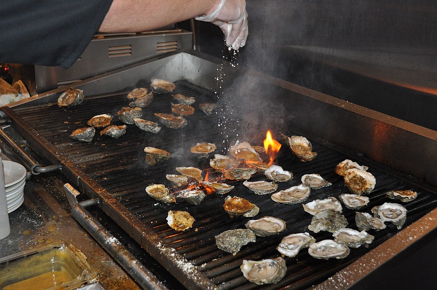 Cooks prepare oysters for the Half Shell Oyster House's opening party on Friday, Jan. 6.