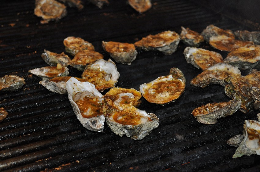 Oysters sit on the grill, ready to be served.