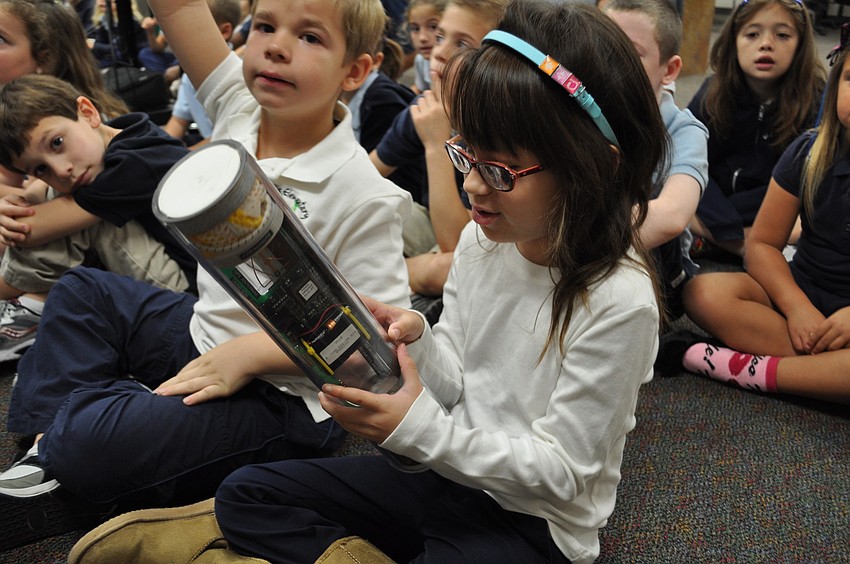 Willis Elementary School first grade student Grace Haddock checks out an instrument used by the National Oceanic  and Atmospheric Administration when it sends crews to fly into hurricanes.