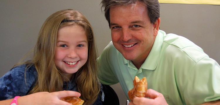 Maddy Hanewich, 9, enjoyed having donuts with her dad, Tim, Friday, Jan. 13, at Imagine School's "Donuts with Dad" event.