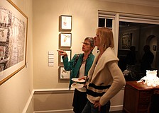 Melanie Dutoit and Muff Calderon look at Tom Stephenses photo, "Grand Entrance", Friday, Jan. 13 at the opening reception of S/ART/Q's Avant Garden at the Marie Selby Botanical Gardens.