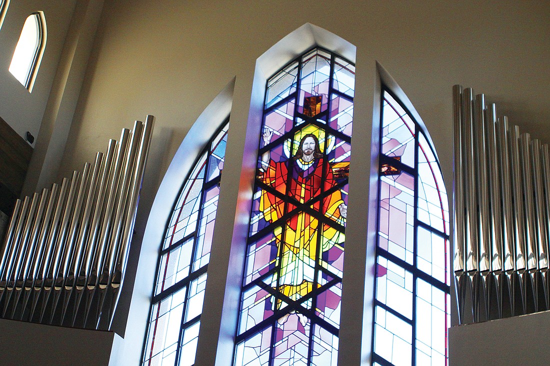 This stained-glass window lies behind the pulpit.