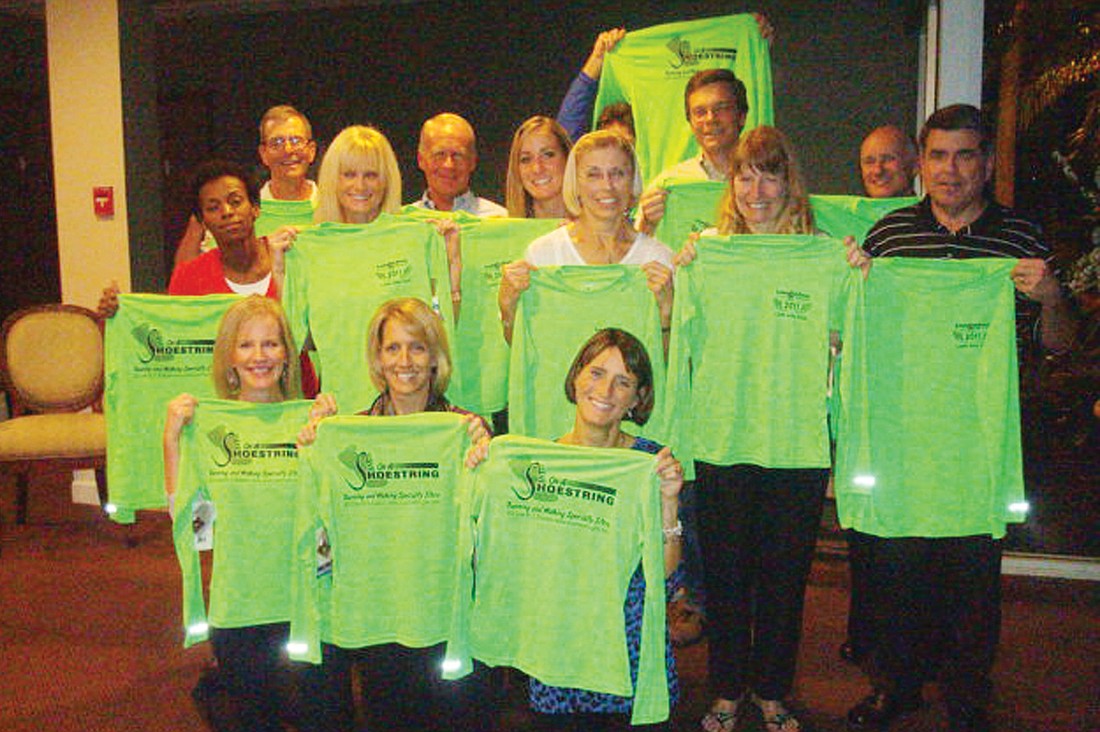 The 17 members of the Lakewood Ranch Running Club who were inducted into the 1,000-Mile Club now have T-shirts to prove it. Courtesy photo.