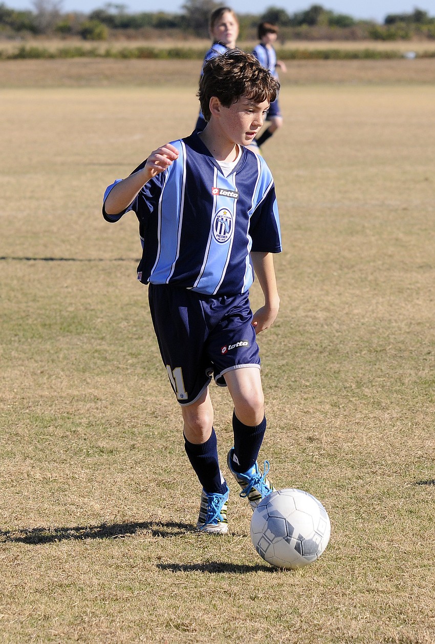 Twelve-year-old Christian Giordano brings the ball up the field for West Florida Premier.