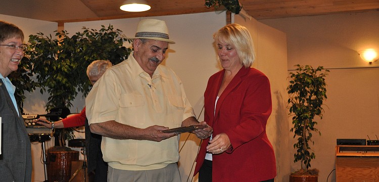 Don Giquinto and Ina Savage accept the first-place award on behalf of Siesta Dunes.
