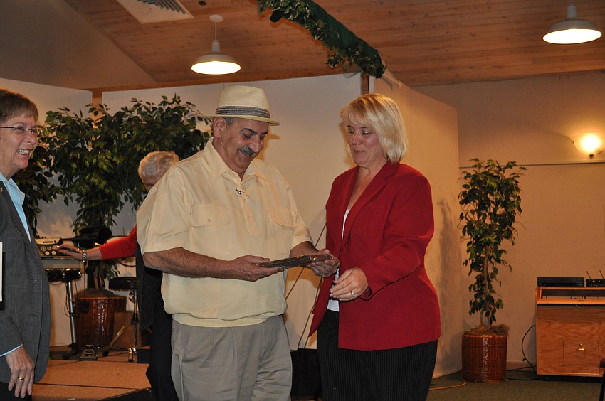 Don Giquinto and Ina Savage accept the first-place award on behalf of Siesta Dunes.