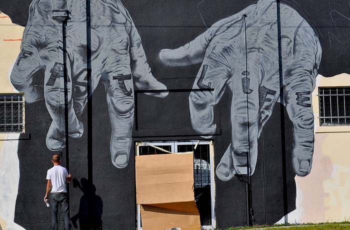 Some neighbors and downtown residents have urged for the removal of the mural and Gerber agreed to do so last month, but the mural still sits on his Tube Dudes plant building at the corner of 10th Street and Central Street.