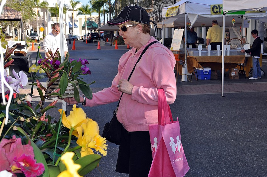 Panther Ridge resident Denise Huelsman couldnâ€™t resist picking up some fresh orchids.