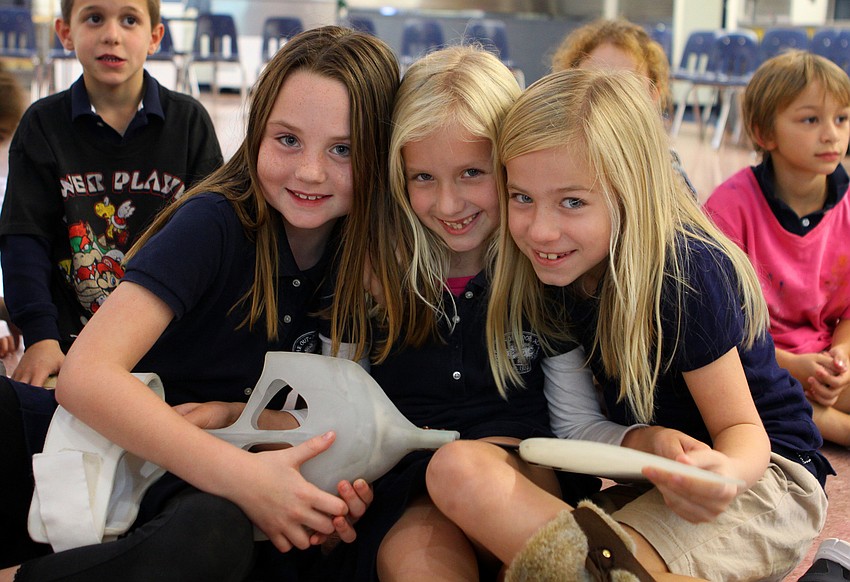 Sara Green, 6, Claire Maag, 6, and Aston Harris, 7, hold one of Winter's tails, Friday, Jan. 20, at Out-of-Door Academy.