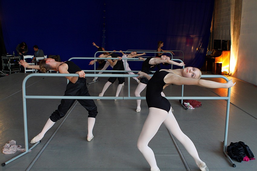 The girls warm up on the barres prior to an open performance for the public at Studio 20 on Pineapple Avenue.