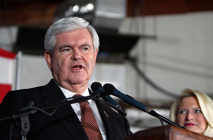 Newt Gingrich speaks as his wife, Callista, looks on, Tuesday, Jan. 24.