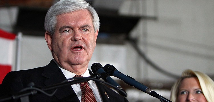 Newt Gingrich speaks as his wife, Callista, looks on, Tuesday, Jan. 24.