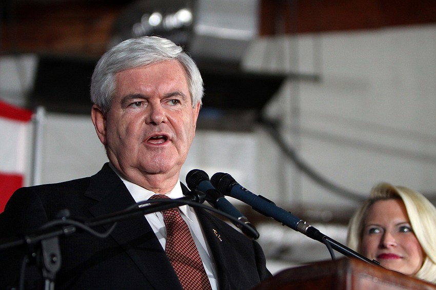 Newt Gingrich speaks as his wife, Callista, looks on, Tuesday, Jan. 24.