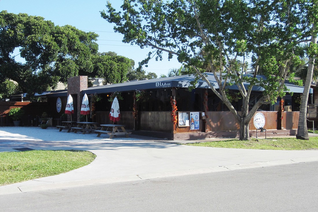 The property leased by Blu Que Island Grill (formerly Blu Smoke), in the Village, is one of the parcels owned by Chris Brown that he contends Sarasota County staff singled out for an excessively high 2011 parking assessment.