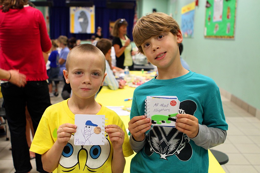 Dylan Interval and Daniel Rodriguez show off their books, Wednesday, Jan. 25, at Bay Haven Elementary.